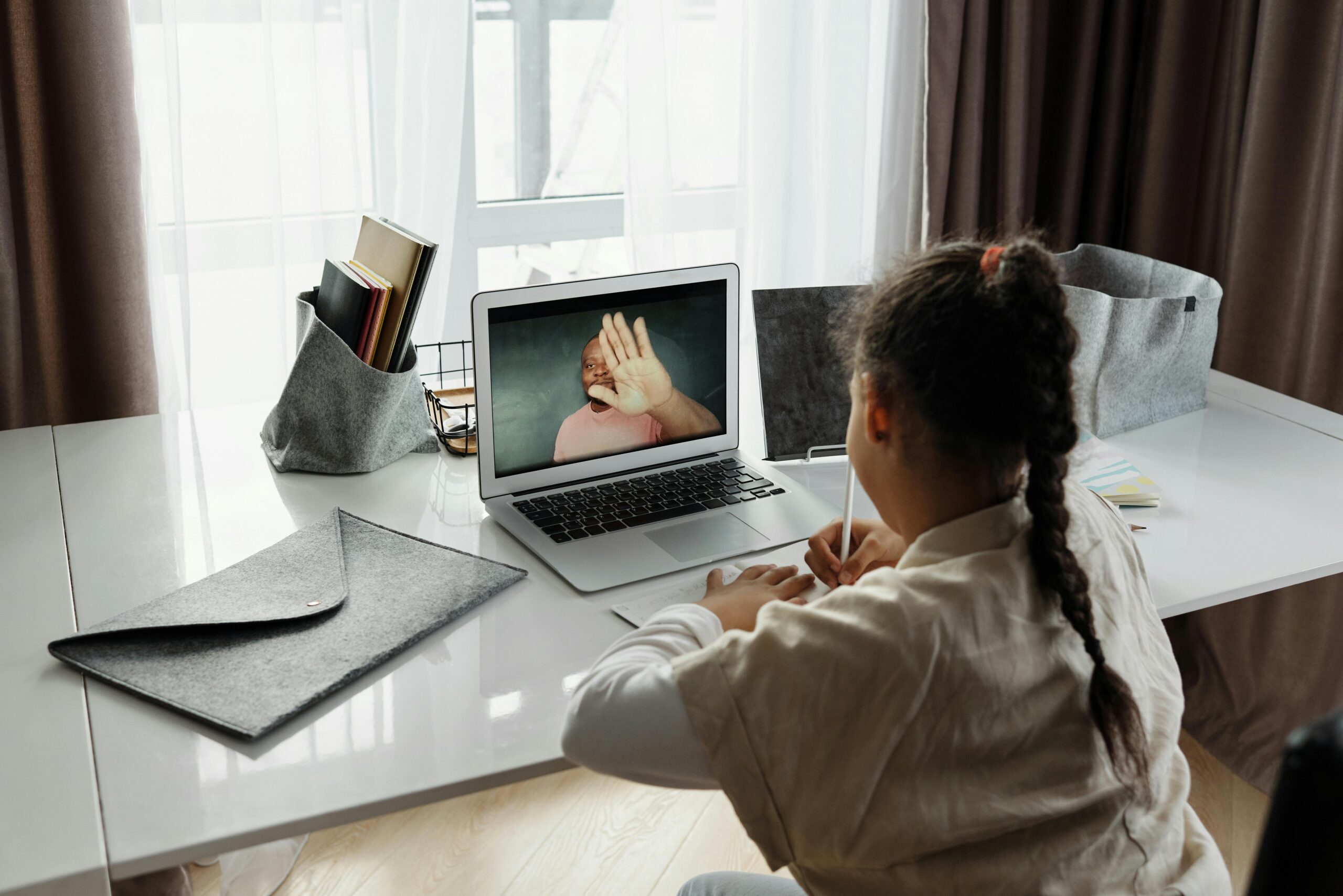 A student at a desk engaged in online learning